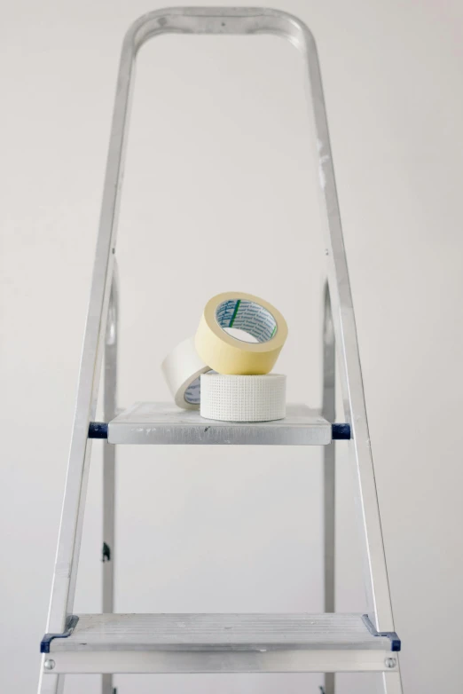 a ladder with a tape on top of it, pexels contest winner, a painting of white silver, commercial product photography, caparisons, ilustration