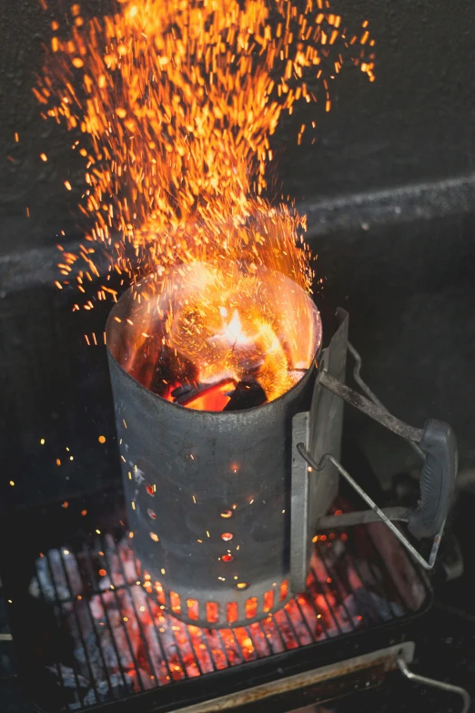 a pot that has some kind of fire in it, auto-destructive art, made up of many bits of metal, pouring, grill, promo image