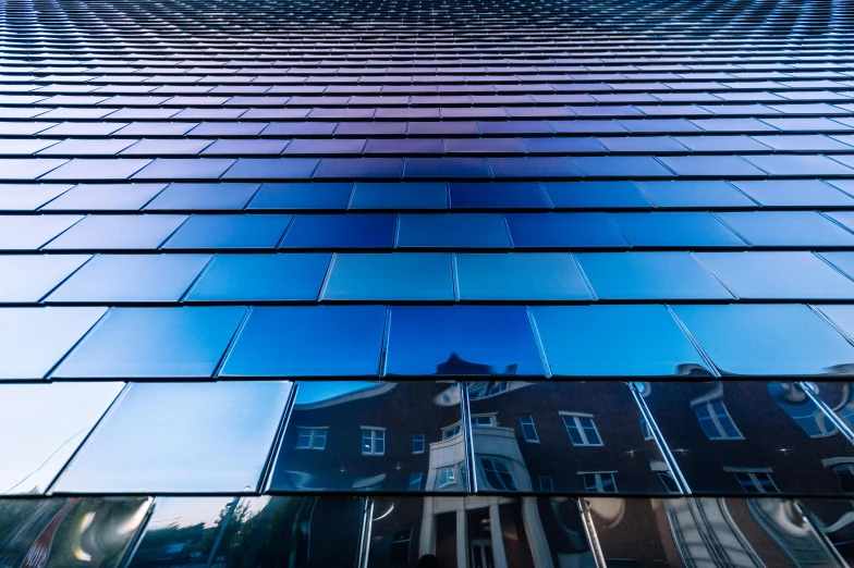 a very tall building with a lot of windows, by Julia Pishtar, unsplash, bauhaus, blue reflections, hannover, thin dof, square lines