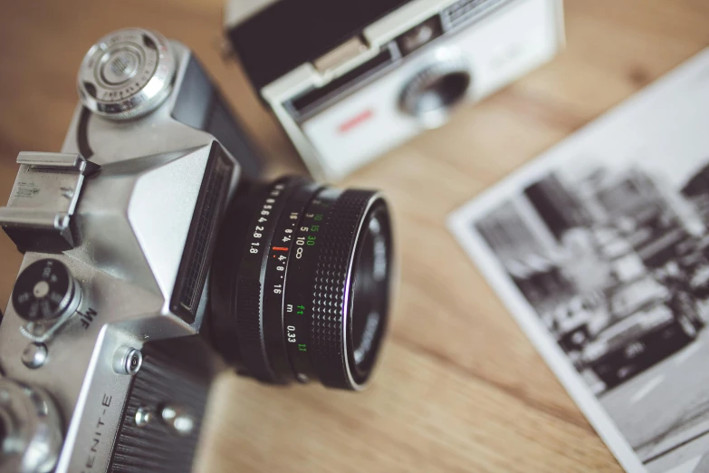 a camera sitting on top of a wooden table, a picture, by Adam Marczyński, pexels contest winner, 1 9 7 0 colour photography, medium format, photograph ”, cute photograph