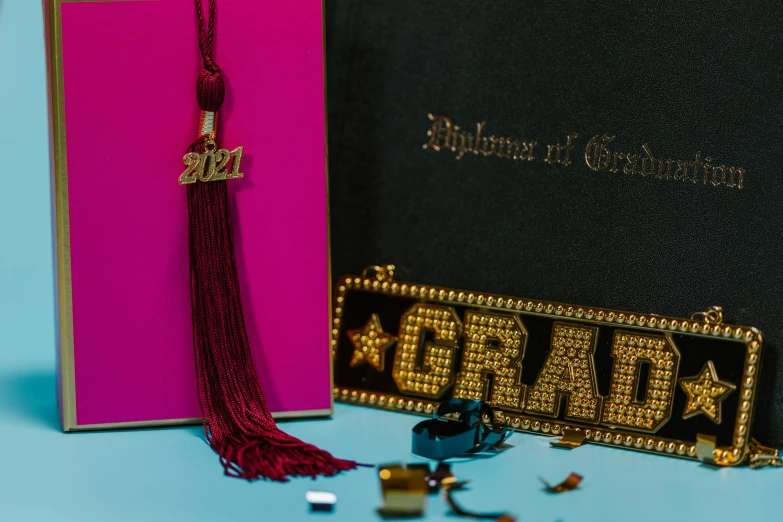 a close up of a book with a tassel, by Julia Pishtar, academic art, bedazzled, various items, graduation photo, thumbnail