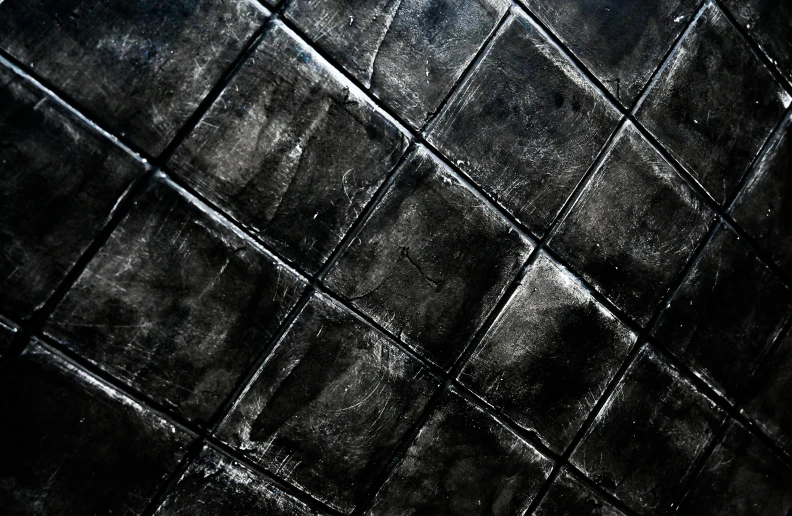 a black and white photo of a tiled floor, an album cover, inspired by Pierre Soulages, deviantart, concrete art, black draconic - leather, realistic skin texture, painted, reptile skin
