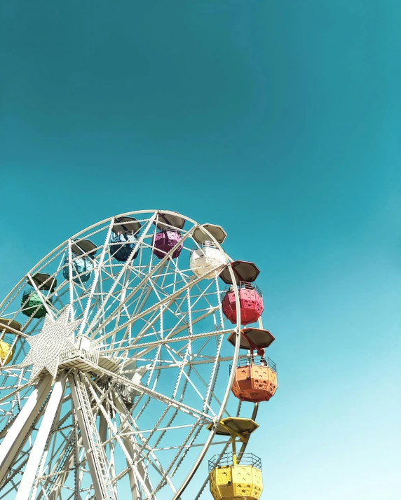 a ferris wheel in front of a blue sky, pexels contest winner, album cover, colourful pastel, profile image, multiple stories