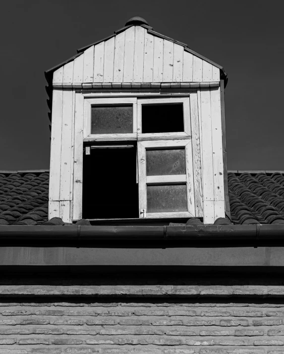 a black and white photo of a window on a building, inspired by August Sander, unsplash, in an attic, terrified, a wooden, rotting