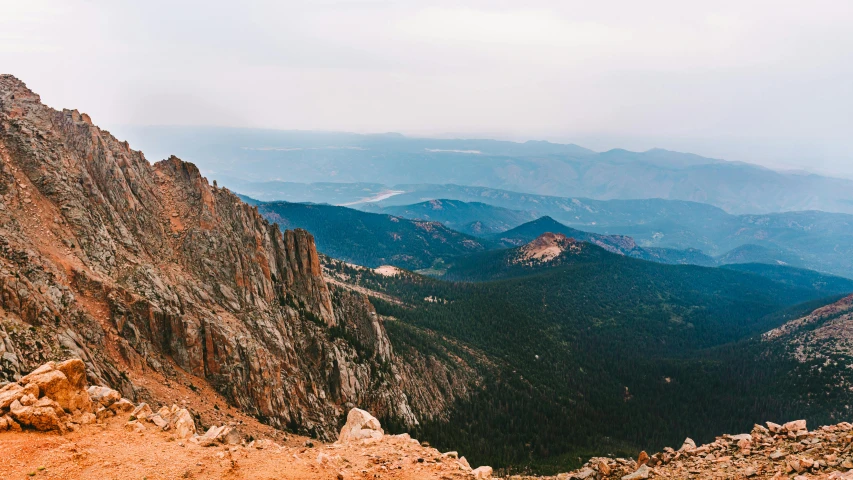 a view of the mountains from the top of a mountain, by Morgan Russell, unsplash contest winner, geological strata, tall spires, colorado mountains, 2000s photo