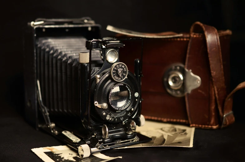 a camera sitting on top of a table next to a wallet, a portrait, art photography, 1920s photography, medium format, ansel ]