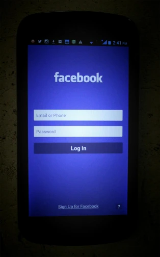 a cell phone sitting on top of a table, happening, facebook profile picture, splashscreen, front lit, doors
