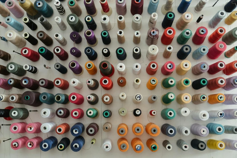 many spools of thread are arranged in a circle, a cross stitch, inspired by Andreas Gursky, unsplash, hyperrealism, museum collection, bedhead, “the ultimate gigachad, an enormous