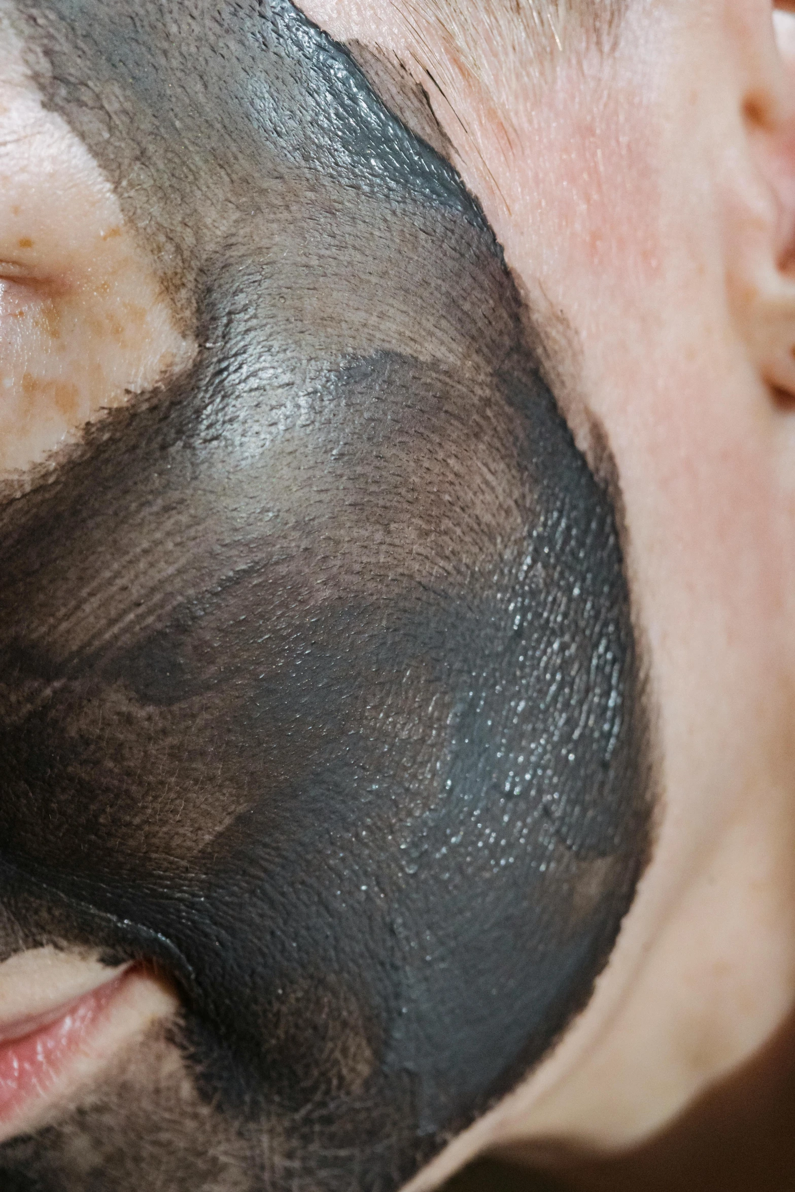 a man with a black mask on his face, using the degrade technique, bottom body close up, no skin shown, clay