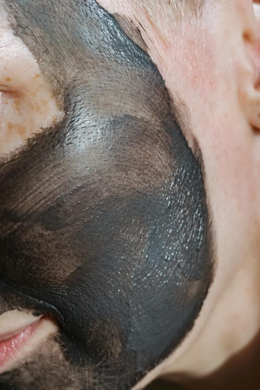 a man with a black mask on his face, using the degrade technique, bottom body close up, no skin shown, clay