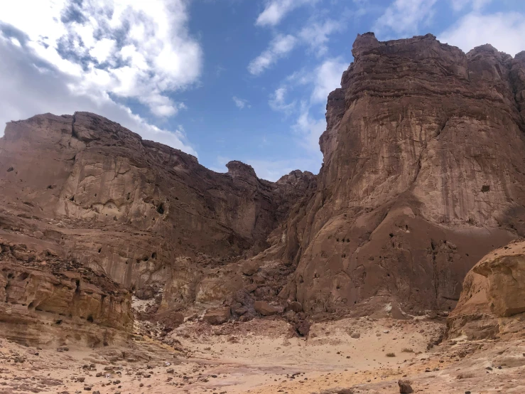 a group of people riding horses through a desert, pexels contest winner, les nabis, highly detailed rock structures, panorama, portrait of bedouin d&d, view from ground level
