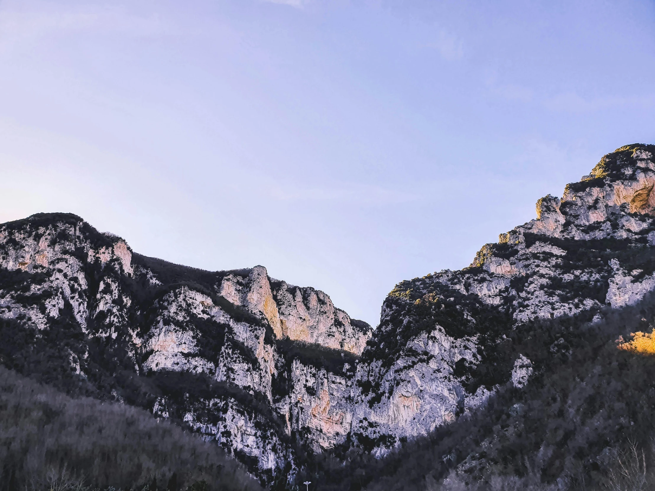 a couple of mountains that are next to each other, by Giuseppe Camuncoli, pexels contest winner, limestone, over a cliff, abbondio stazio, early evening