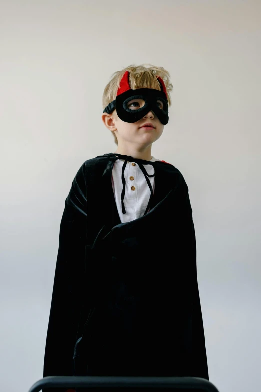 a little boy dressed up in a batman costume, an album cover, pexels, purism, pirate, masqua, full size persona