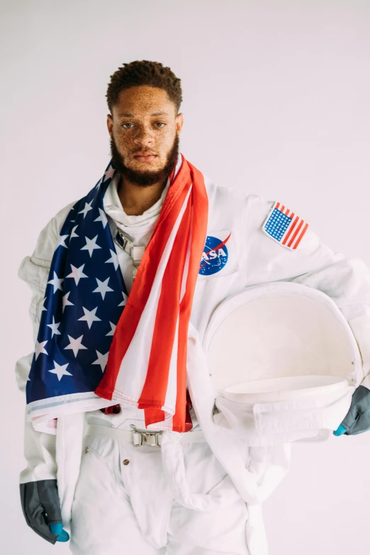 a man in an astronaut suit holding an american flag, an album cover, inspired by Jules Tavernier, trending on unsplash, renaissance, pete davidson, an all white human, afroamerican, photo from a promo shoot