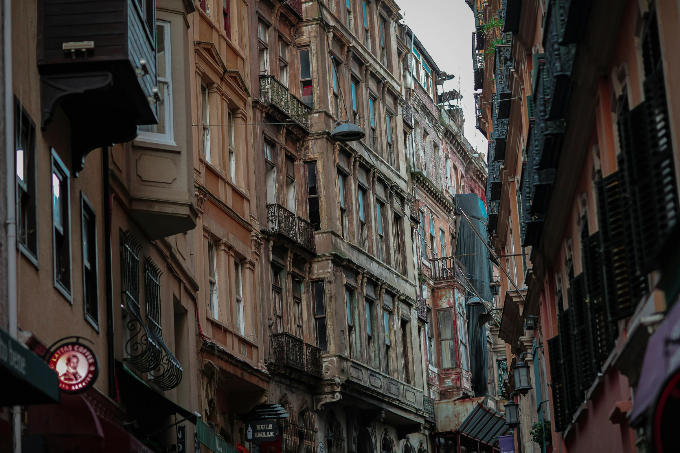 a city street filled with lots of tall buildings, a picture, renaissance, wrought iron architecture, profile image, faded colours, close - up photo