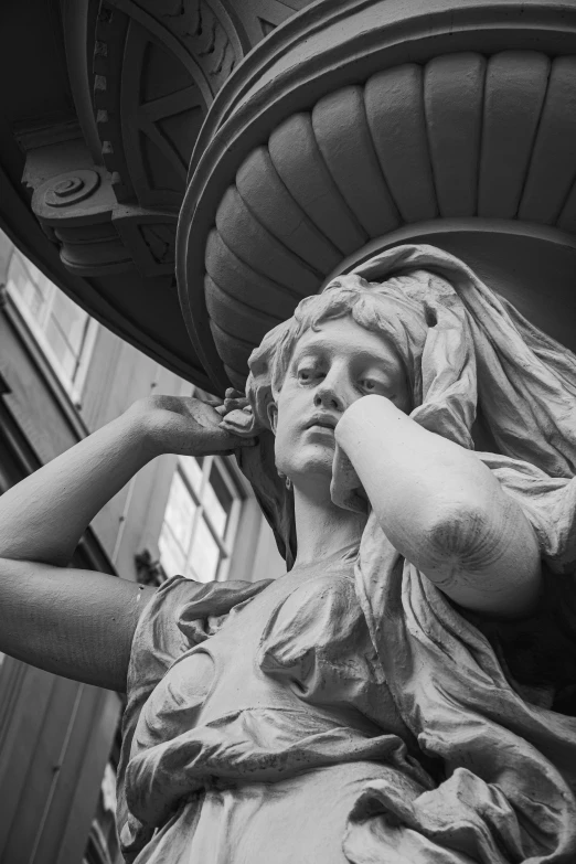 a black and white photo of a statue, a statue, inspired by Antonio Canova, pexels contest winner, girl with warship parts, her hair is tied above her head, taken in the late 2010s, sardax