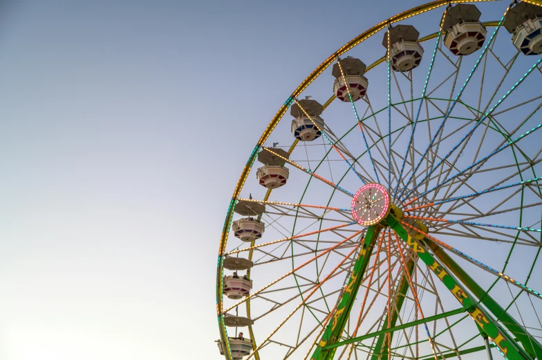 a ferris wheel in front of a blue sky, a portrait, pexels contest winner, avatar image, pastel sky, 1 2 9 7, a green