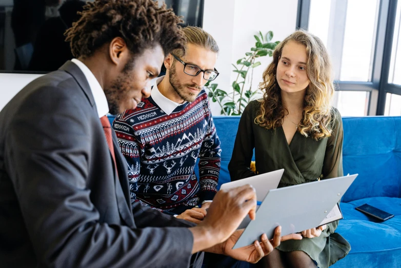 three people sitting on a couch looking at a laptop, pexels, corporate boss, te pae, thumbnail, raphael lecoste