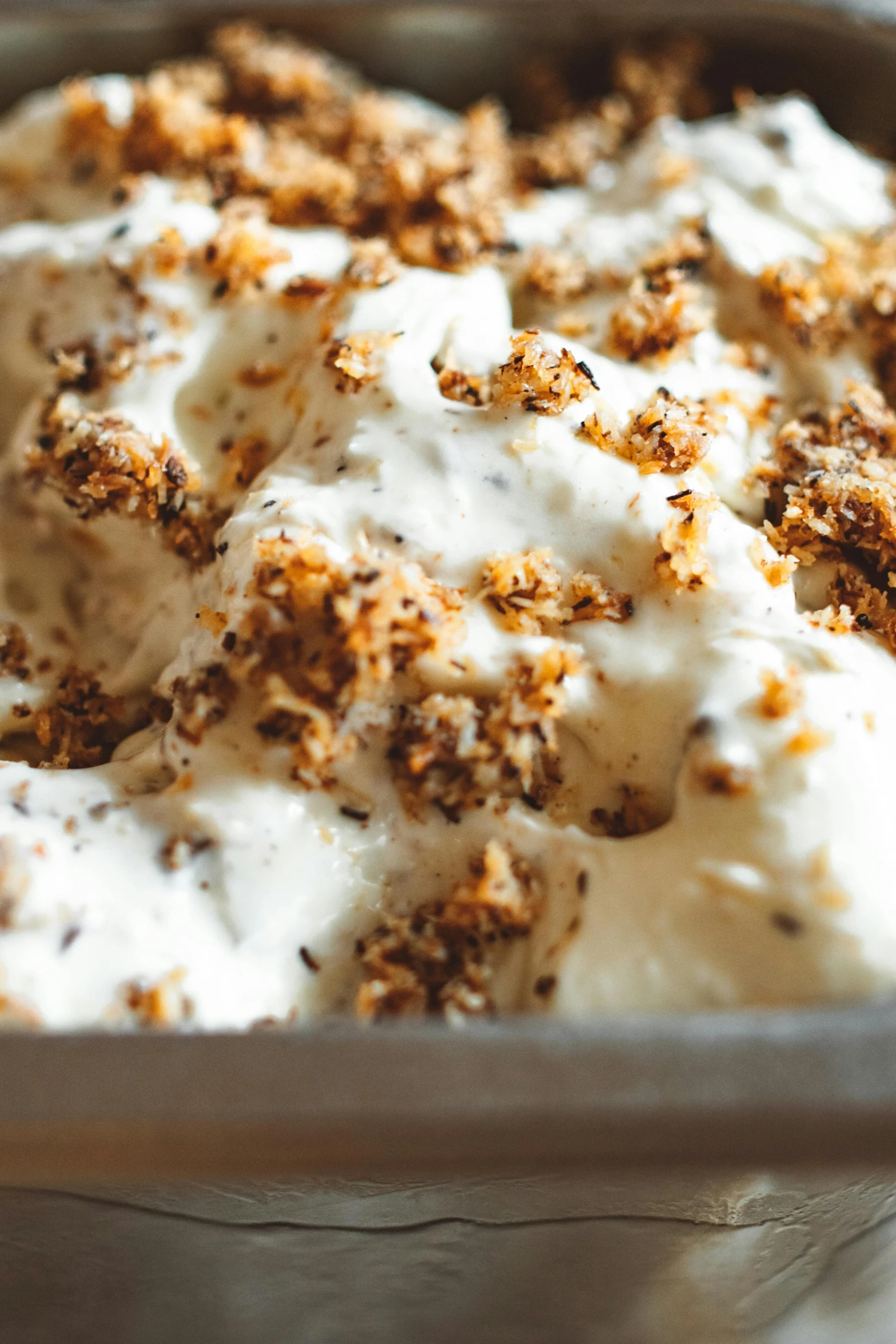 a close up of a pan of food on a table, ice cream on the side, seeds, thumbnail, frosted