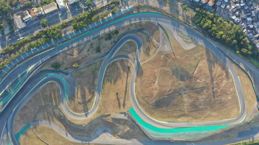 an aerial view of a race track in a city, pexels contest winner, conceptual art, flowing curves, sydney park, jerez, thumbnail