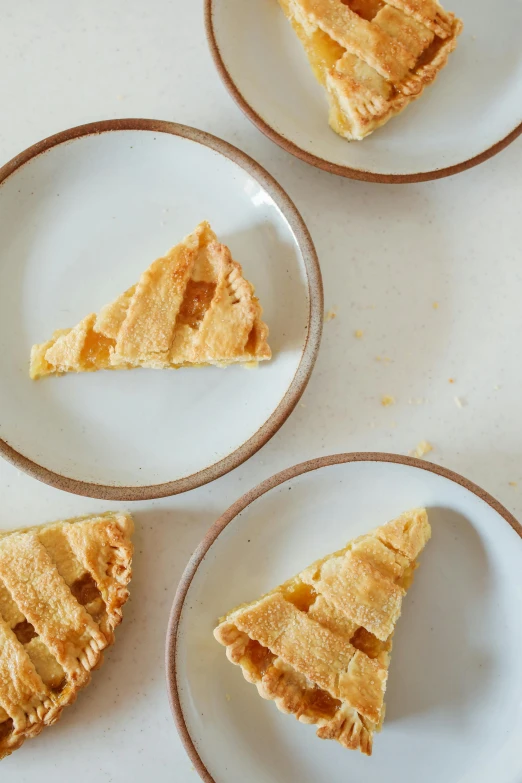 three plates with slices of pie on them, a still life, trending on unsplash, 2 5 6 x 2 5 6 pixels, lattice, john pawson, yellow