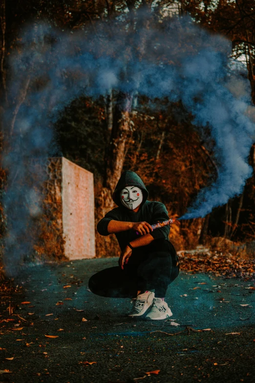 a man wearing a mask with smoke coming out of his mouth, an album cover, pexels contest winner, graffiti, ritual in a forest, smoking with squat down pose, 2019 trending photo, halloween