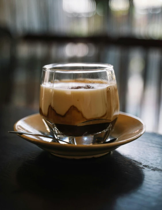 a cup of coffee sitting on top of a saucer, iced latte, multiple stories, thumbnail, indonesia