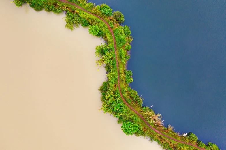 an aerial view of a road next to a body of water, by Carey Morris, pexels contest winner, environmental art, plain background, planet overgrown, 4k detail post processing, rail tracks lead from the mine