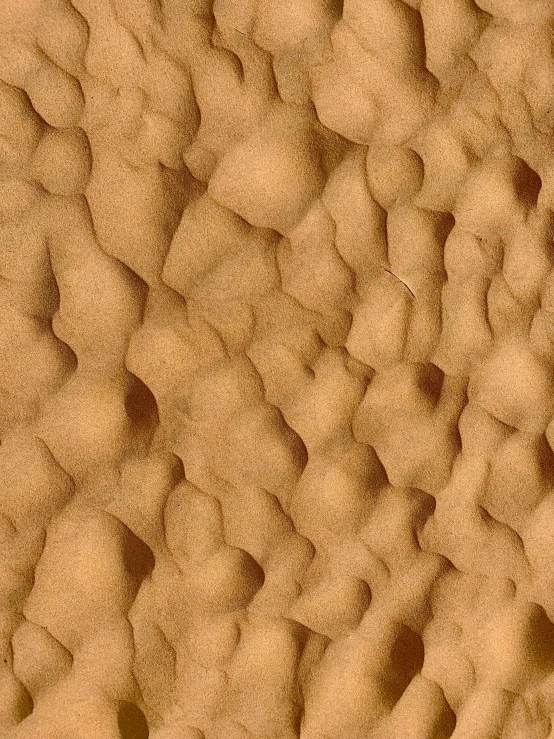 a close up of some sand on a beach, inspired by Mac Conner, trending on zbrush central, on the surface of mars, 3d printed line texture, light - brown wall, marshmallow graham cracker