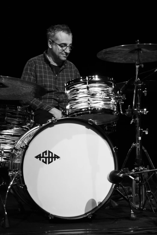 a man that is sitting in front of a drum, an album cover, by Dave Melvin, flickr, in black and white, sam nassour, john romita senior, 15081959 21121991 01012000 4k