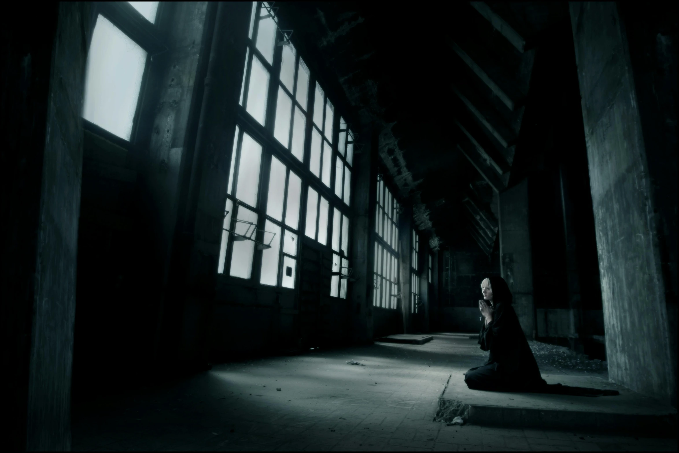 a woman sitting on the ground in a dark room, an album cover, inspired by Elsa Bleda, deviantart, gothic art, [[empty warehouse]] background, still from a music video, standing in a large empty hall, unreal engine. film still