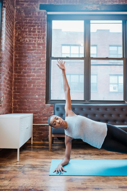 a woman doing a yoga pose in front of a window, by Emma Lampert Cooper, trending on unsplash, portra 8 0 0 ”, brooklyn, panoramic shot, sigma 55”