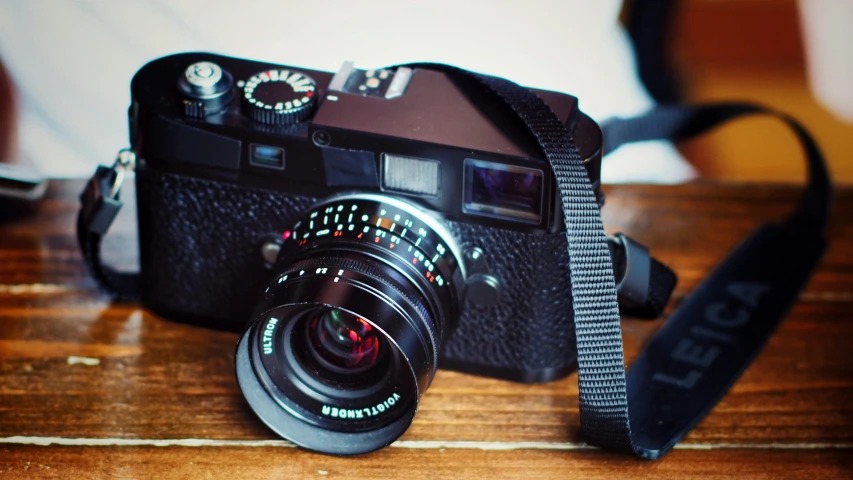 a camera sitting on top of a wooden table, a picture, leica noctilux, impeccable military composure, lofi, grainy