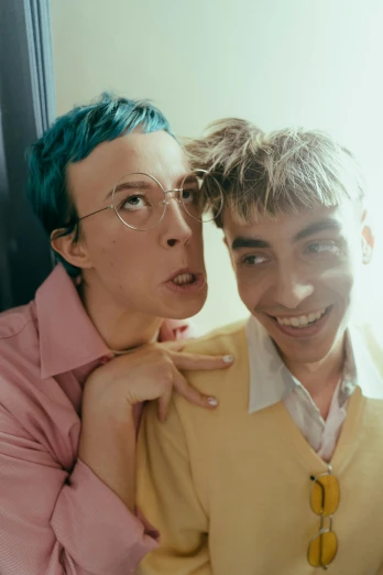 a couple of people standing next to each other, an album cover, trending on pexels, antipodeans, teal eyebrows, non-binary, ( ( theatrical ) ), two buddies sitting in a room