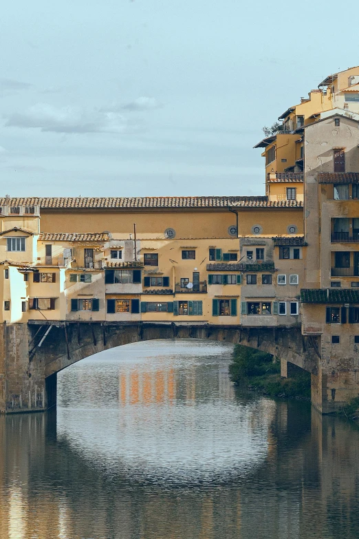 a bridge over a body of water with buildings in the background, renaissance, sienna, slide show, photograph