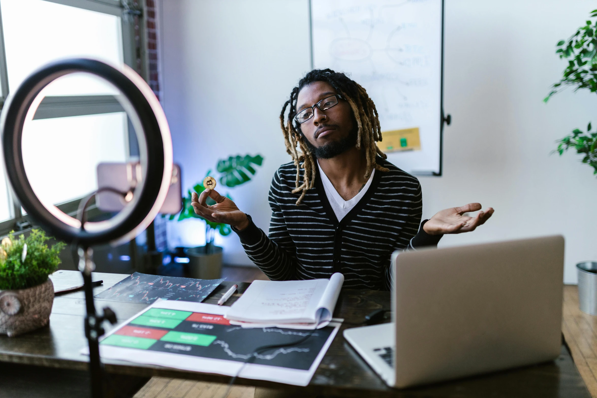 a man sitting at a desk in front of a laptop, trending on pexels, afrofuturism, teaching, in small room, looking confused, awards winning