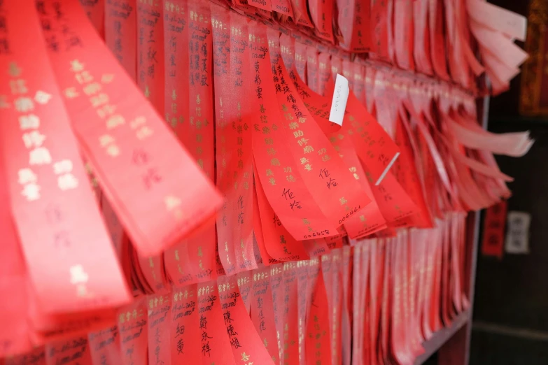 a wall of red paper with chinese writing on it, pexels contest winner, symbolism, wide ribbons, mid - shot, keng lye, we go