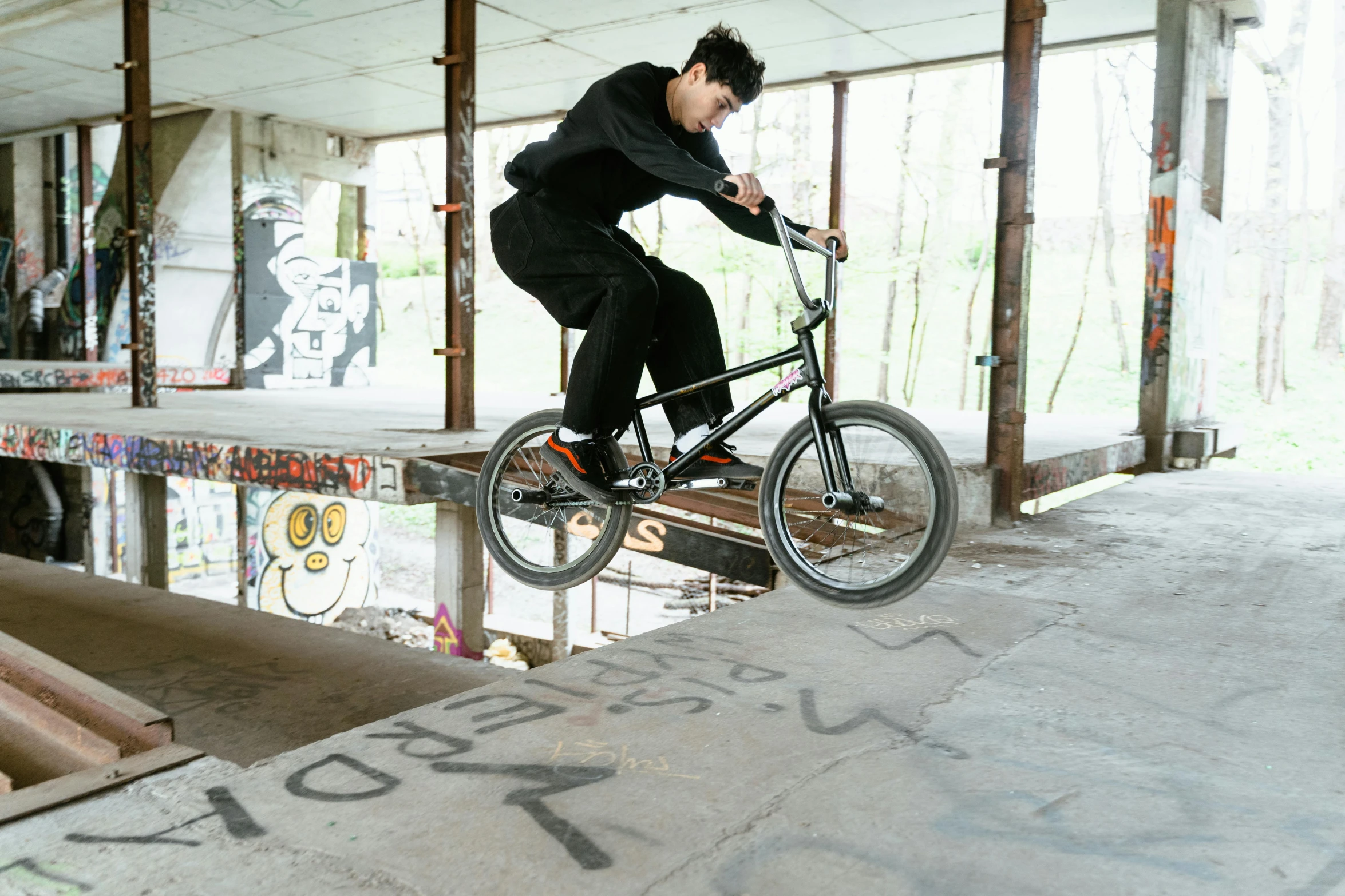 a man flying through the air while riding a bike, unsplash, realism, yung lean, cement, detailed surroundings, 2 0 0 0's photo