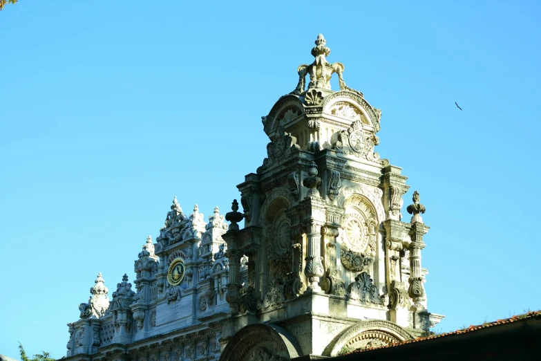 a very tall building with a clock on it's side, an album cover, inspired by Francisco de Burgos Mantilla, pexels contest winner, baroque, tiled roofs, holy place, godrays from the right, black