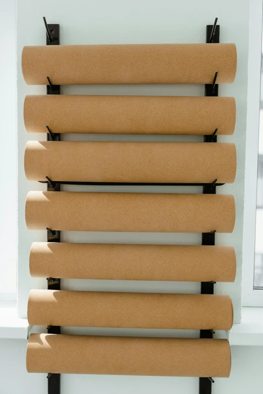 a close up of a towel rack on a wall, inspired by Donald Judd, cardboard tunnels, lined up horizontally, layered paper, rubber