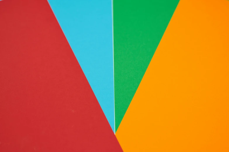 a bunch of different colored papers sitting on top of each other, a minimalist painting, inspired by Ellsworth Kelly, unsplash, medium closeup, large triangular shapes, color ( sony a 7 r iv, green bright red