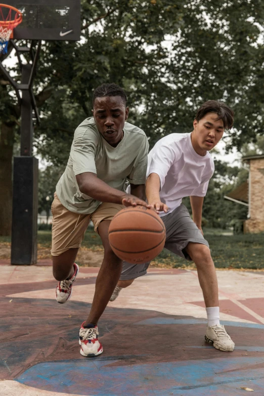 a couple of men playing a game of basketball, trending on dribble, asian descent, promo photo, college, looking towards camera