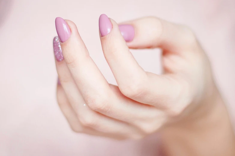 a close up of a person's hand with a pink manicure, trending on pexels, animation, lilac, colour corrected, porcelain skin ”