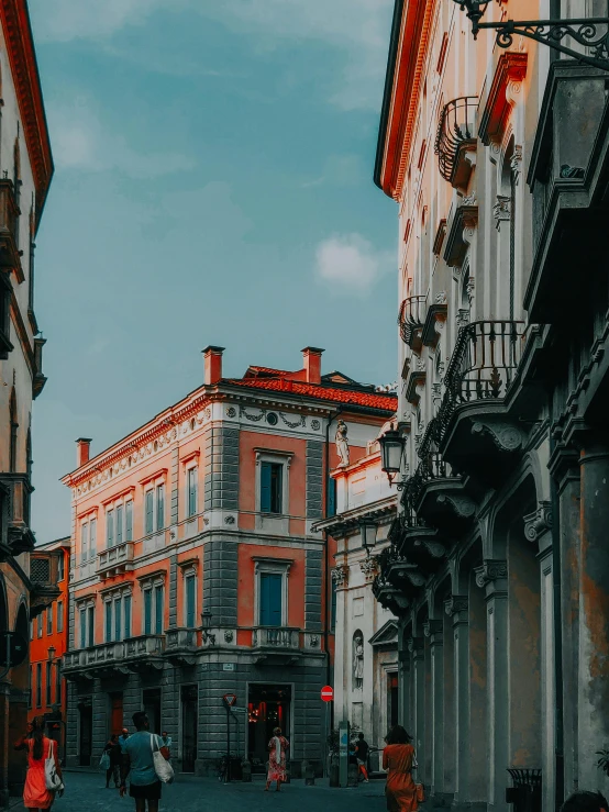 a group of people walking down a street next to tall buildings, inspired by Bernardo Bellotto, pexels contest winner, neoclassicism, italian renaissance architecture, profile image, spanish, gray and orange colours