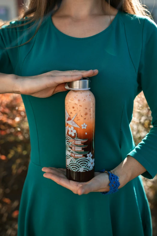 a woman in a green dress holding a bottle of coffee, inspired by Kanō Tan'yū, graffiti, sustainable materials, at sunrise, beautiful intricate glass bottle, thumbnail