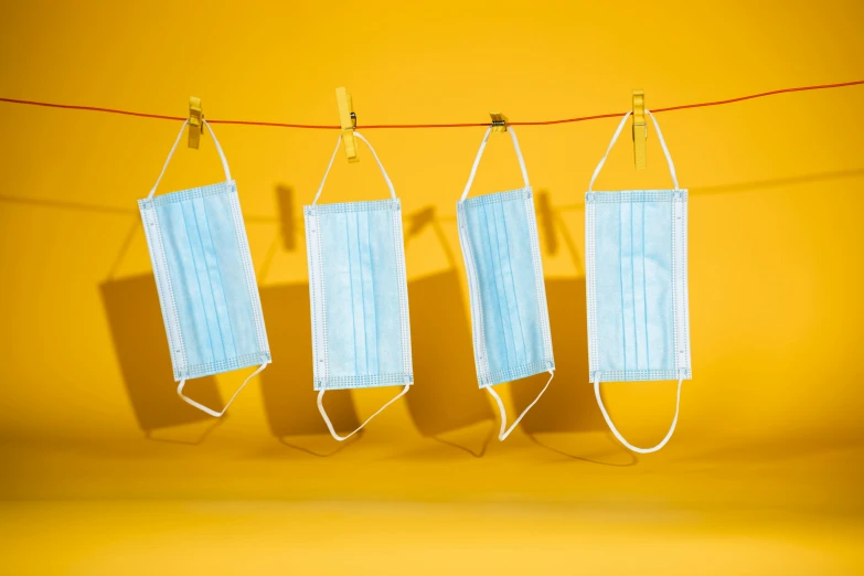 three surgical masks hanging on a clothes line, an album cover, trending on pexels, plasticien, yellow backdrop, 6 pack, profile pic, light blues