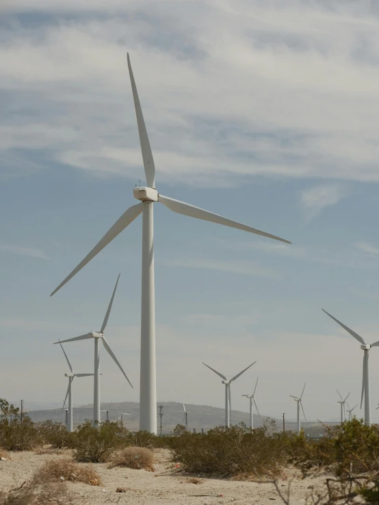 a group of wind turbines in the desert, by Carey Morris, slide show, cinematic composition 8 k, uncrop, clean image