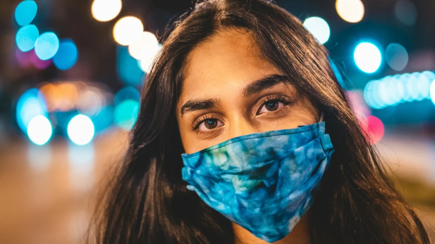 a close up of a person wearing a face mask, trending on pexels, hurufiyya, mia khalifa, made of lab tissue, festival vibes, at night