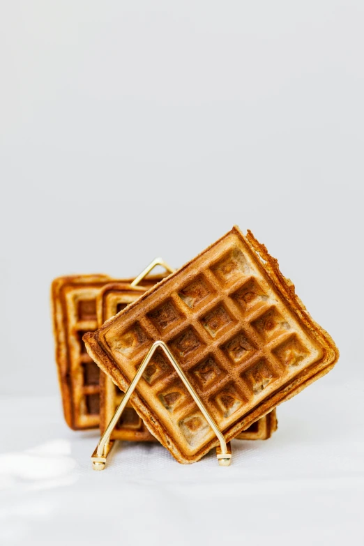 a stack of waffles sitting on top of each other, brass plated, fan favorite, frontal shot, multiple stories