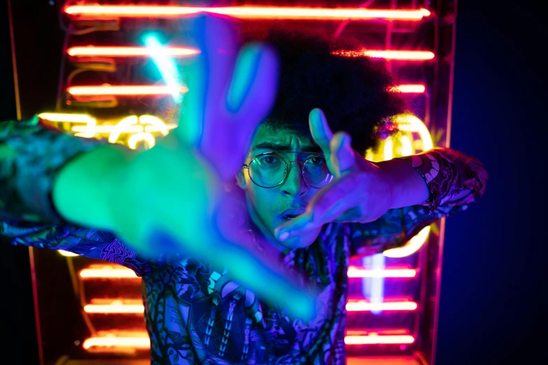 a man standing in front of a neon sign, pexels, blacklight reacting, ashteroth, in an action pose, disco party